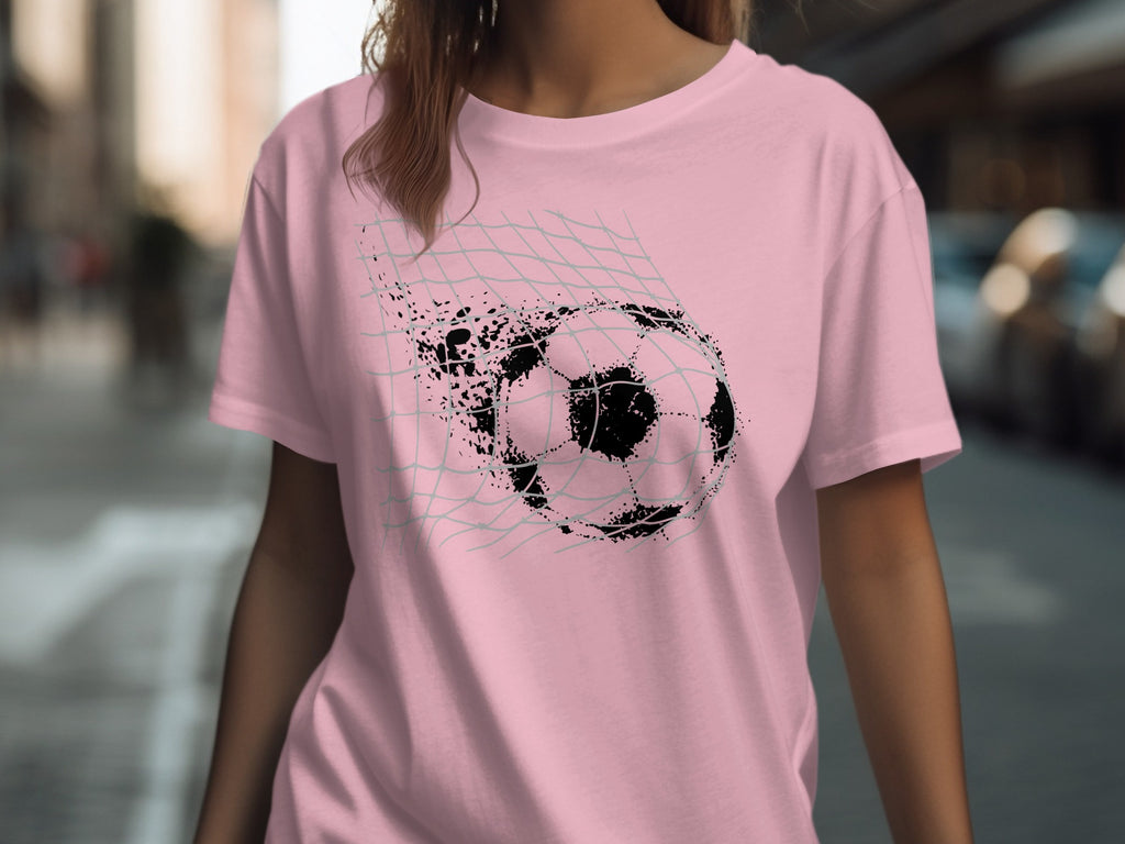 Pink t-shirt with a distressed soccer ball going through a net graphic.
