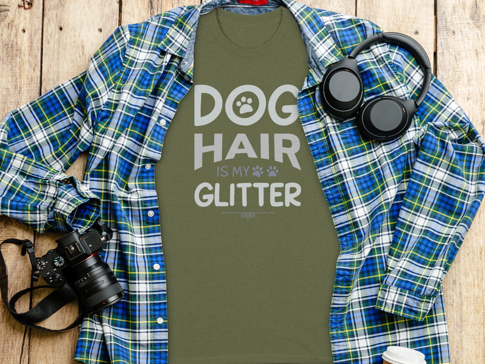 Olive green t-shirt with text "DOG HAIR IS MY GLITTER" under a plaid shirt.