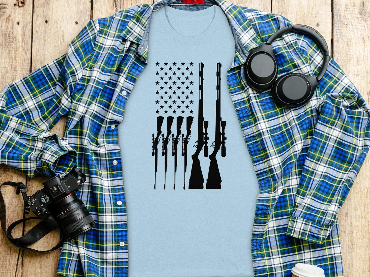 Light blue t-shirt with black silhouette of rifles and stars forming the American flag.