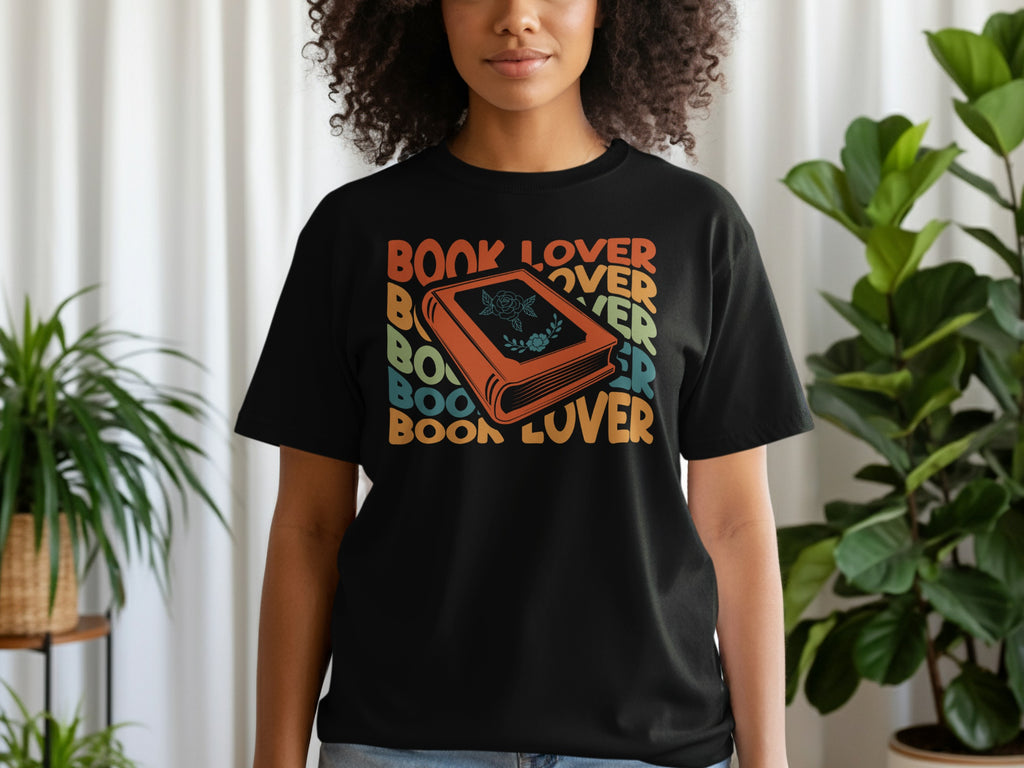 Black t-shirt with retro "Book Lover" text and a stylized orange book graphic.