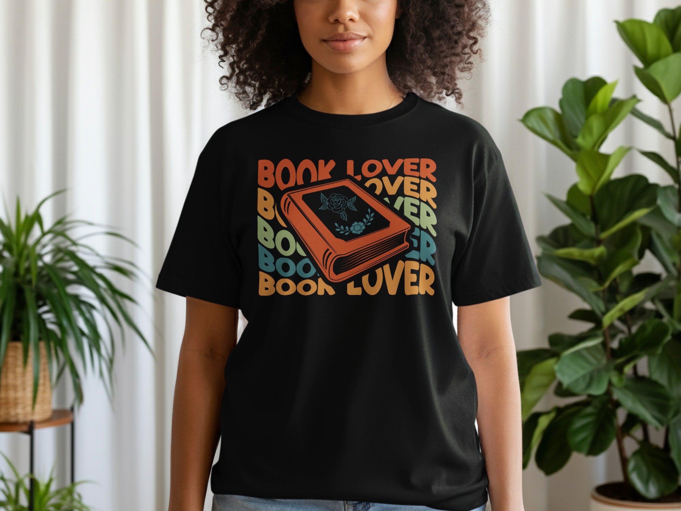Black t-shirt with retro "Book Lover" text and a stylized orange book graphic.