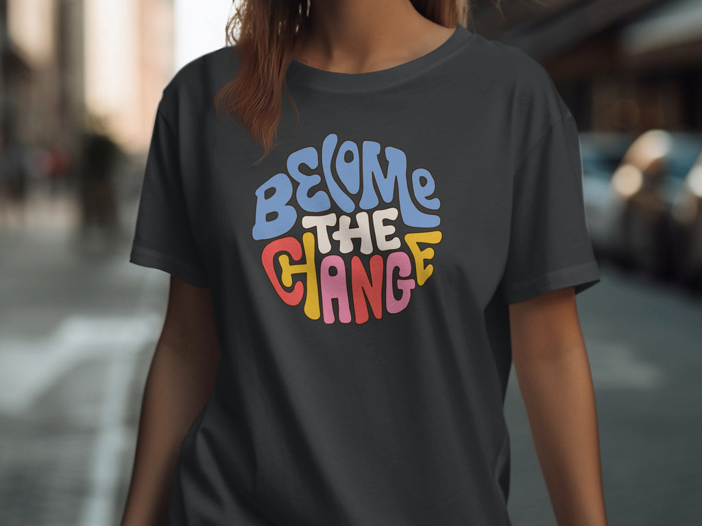 Dark gray t-shirt with "BECOME THE CHANGE" in a circular, colorful retro font.
