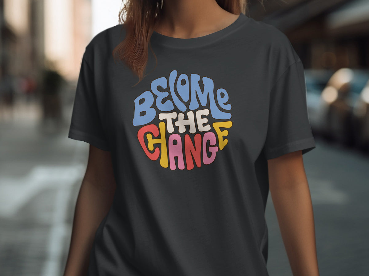 Dark gray t-shirt with "BECOME THE CHANGE" in a circular, colorful retro font.