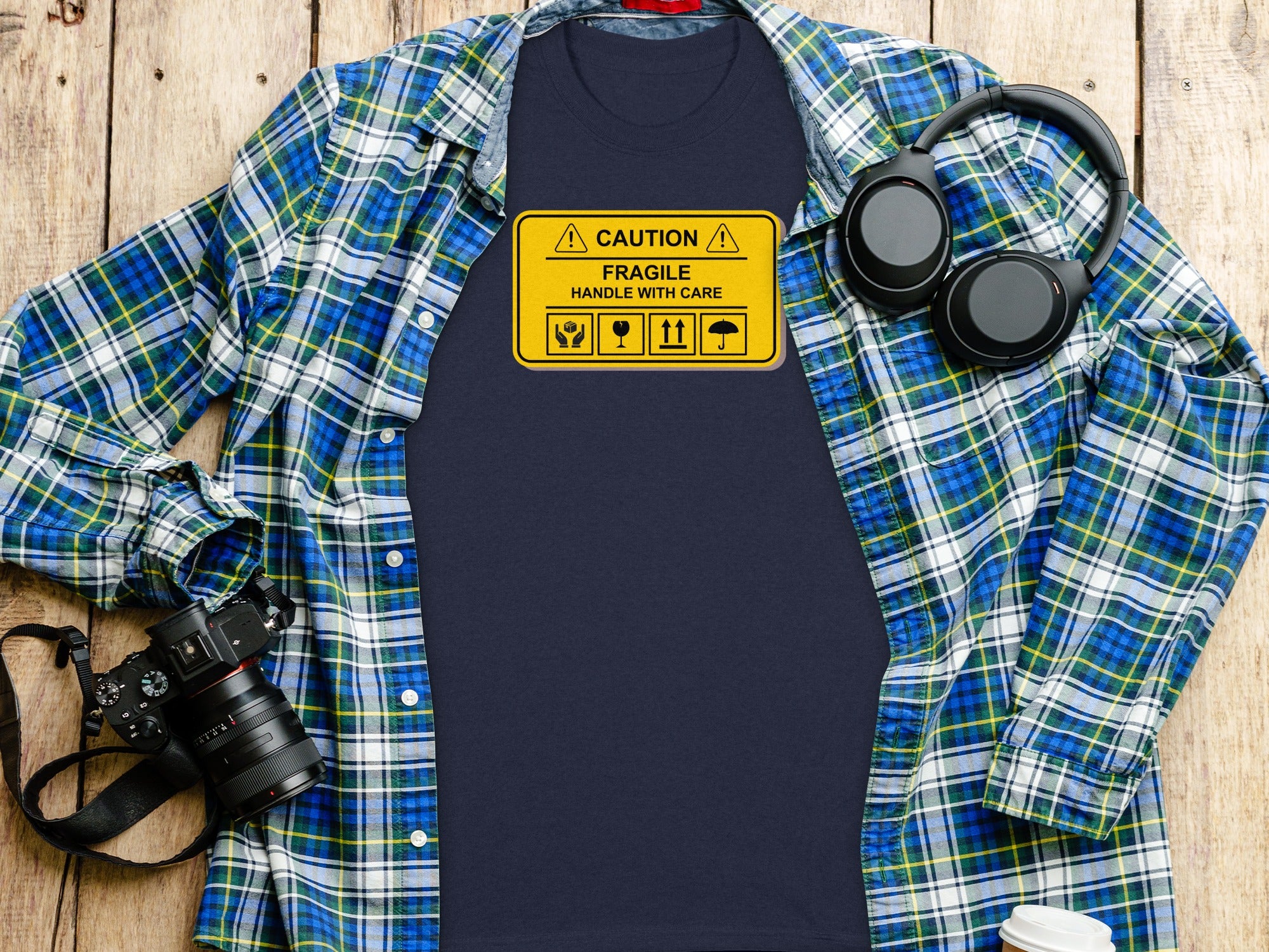 Navy t-shirt with "Caution Fragile Handle With Care" graphic and icons.