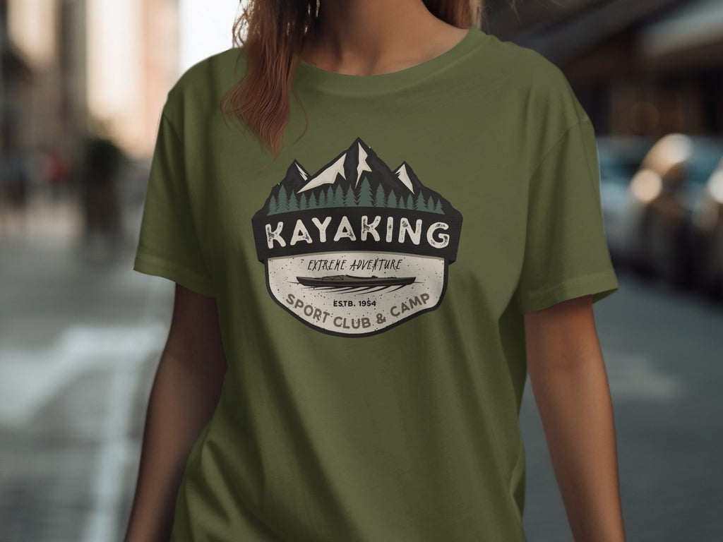 Olive green t-shirt with "KAYAKING EXTREME ADVENTURE SPORT CLUB & CAMP ESTB. 1954" graphic.
