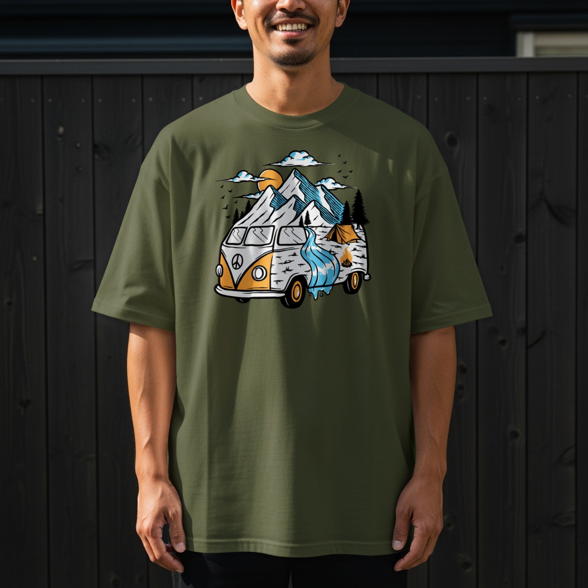 Vintage van with mountains, river, sun, and campsite illustration on olive t-shirt.