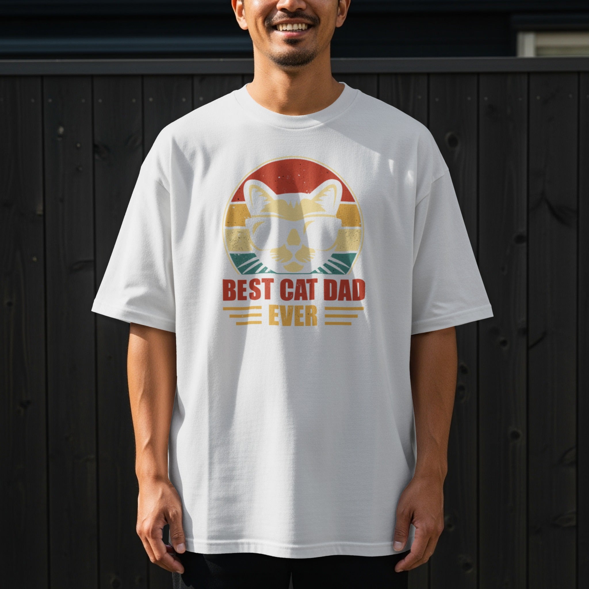 White t-shirt with a graphic of a cat wearing sunglasses and the text "BEST CAT DAD EVER".