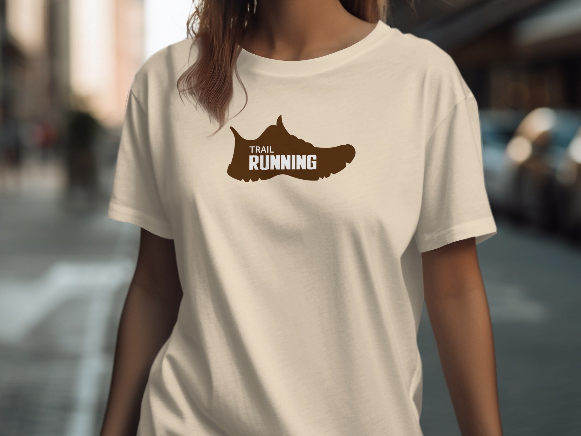 Cream t-shirt with brown trail running shoe graphic and text.