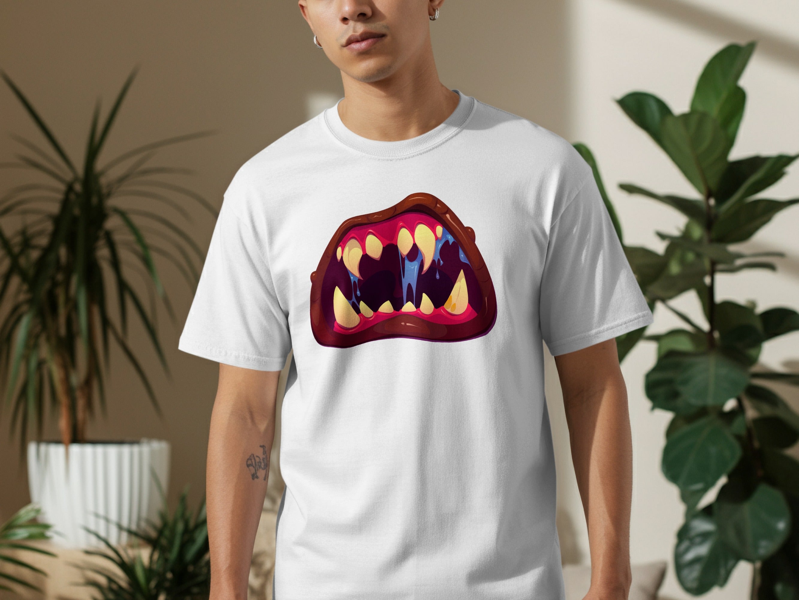White t-shirt with a cartoonish open mouth graphic with sharp teeth and dripping blue saliva.