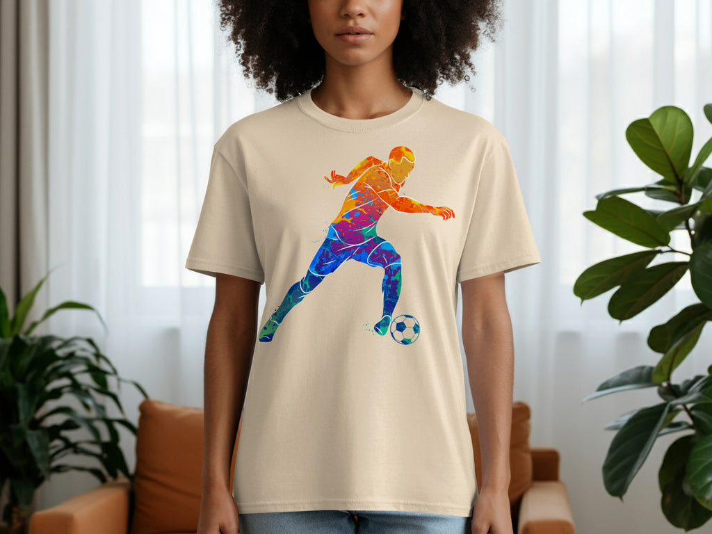 Tan t-shirt with colorful watercolor soccer player and ball graphic.