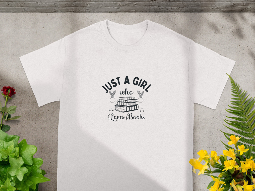 White t-shirt with "Just a girl who loves books" text and book illustration.