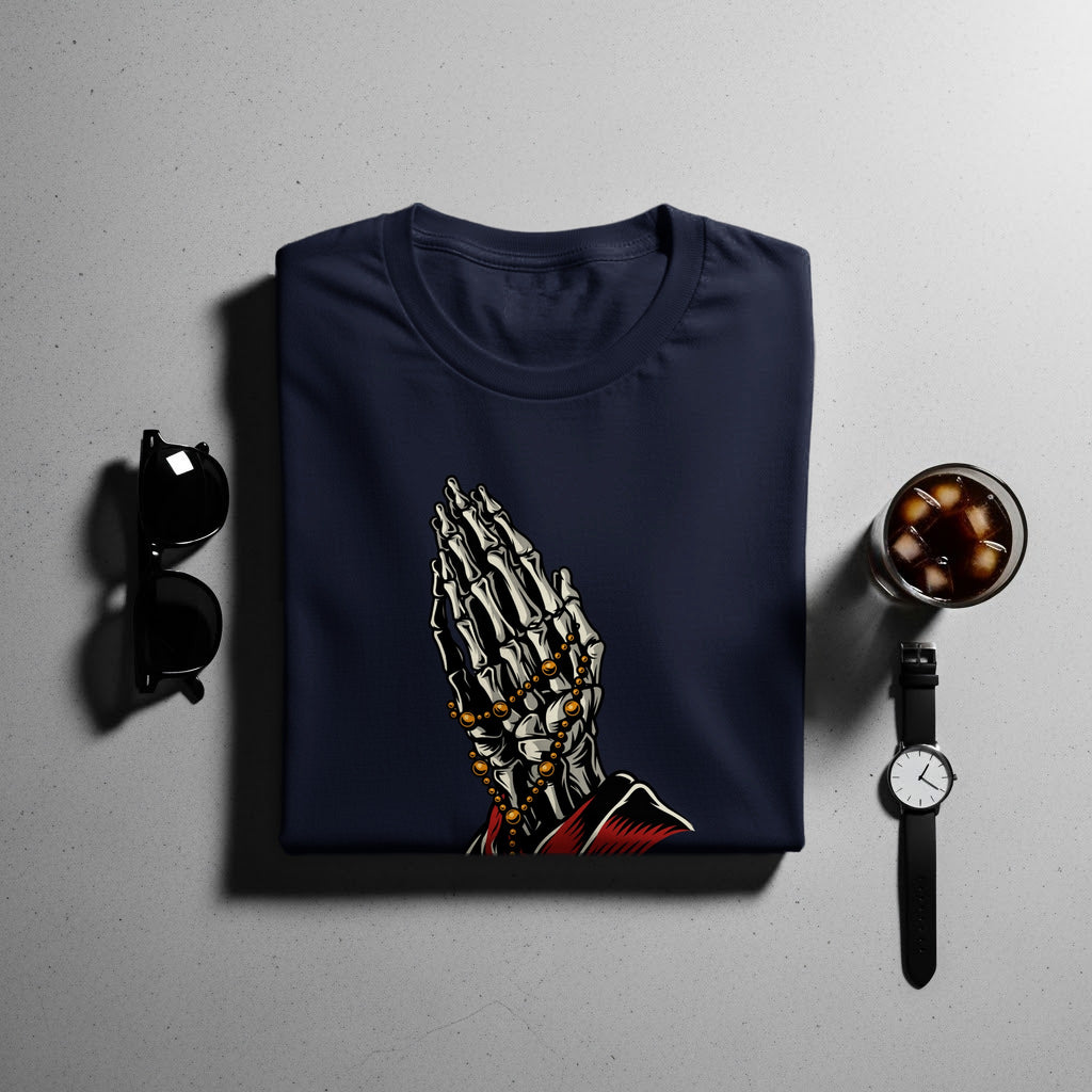 Navy t-shirt with skeleton praying hands graphic and gold beads.