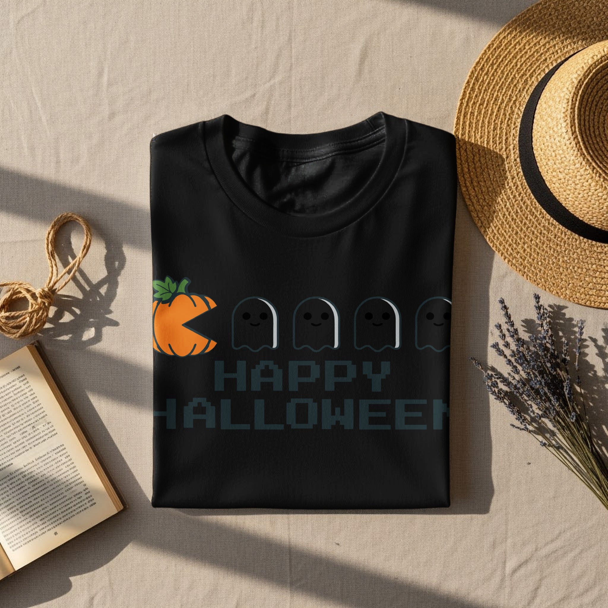 Black t-shirt with a graphic of a pumpkin Pac-Man chasing ghosts and "HAPPY HALLOWEEN" text.