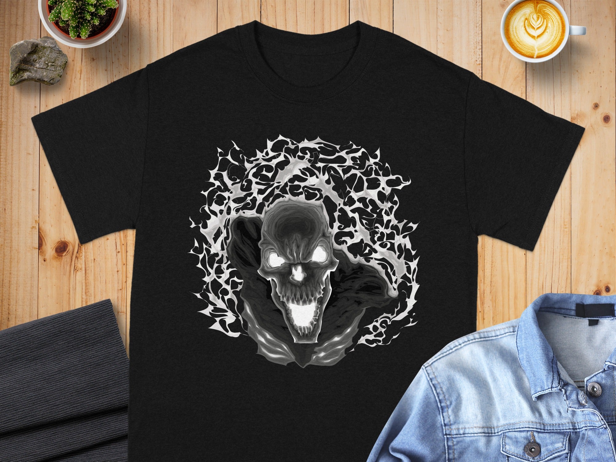 Black t-shirt with a grayscale abstract skull graphic surrounded by lightning.