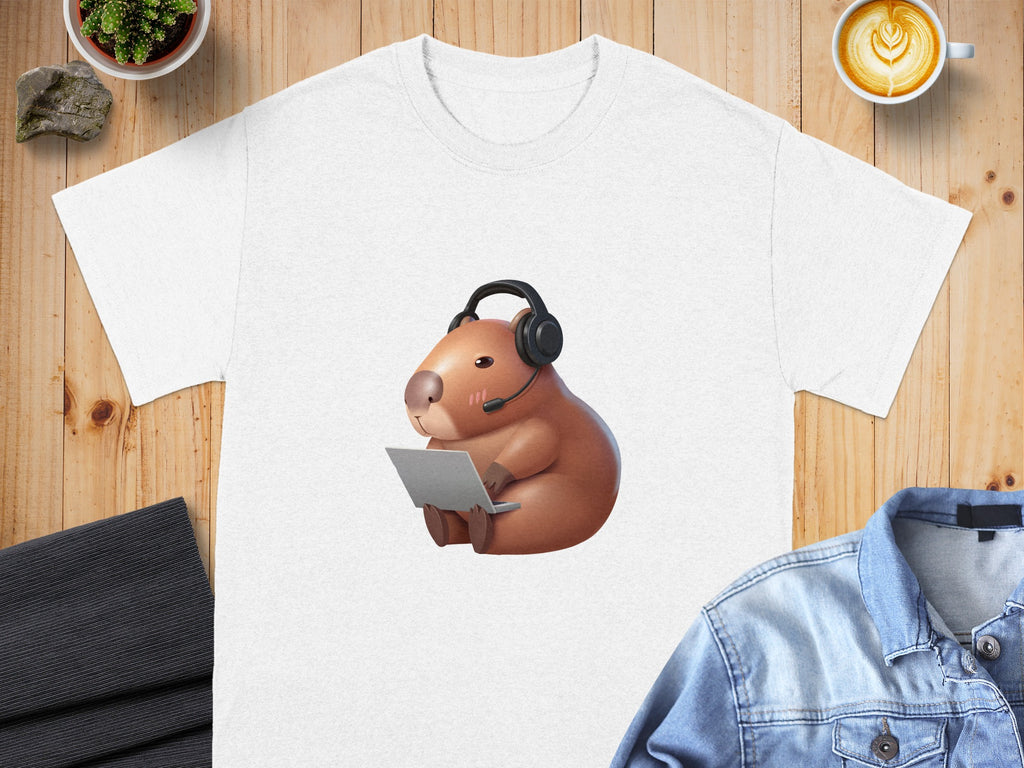 Capybara wearing headset and working on a laptop on a white t-shirt.