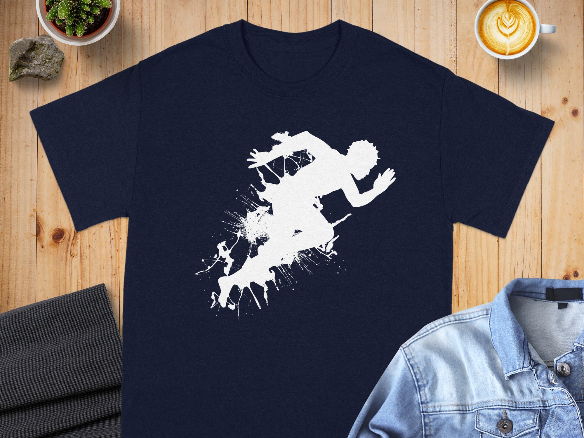 Navy t-shirt with white abstract runner silhouette and ink splatters.