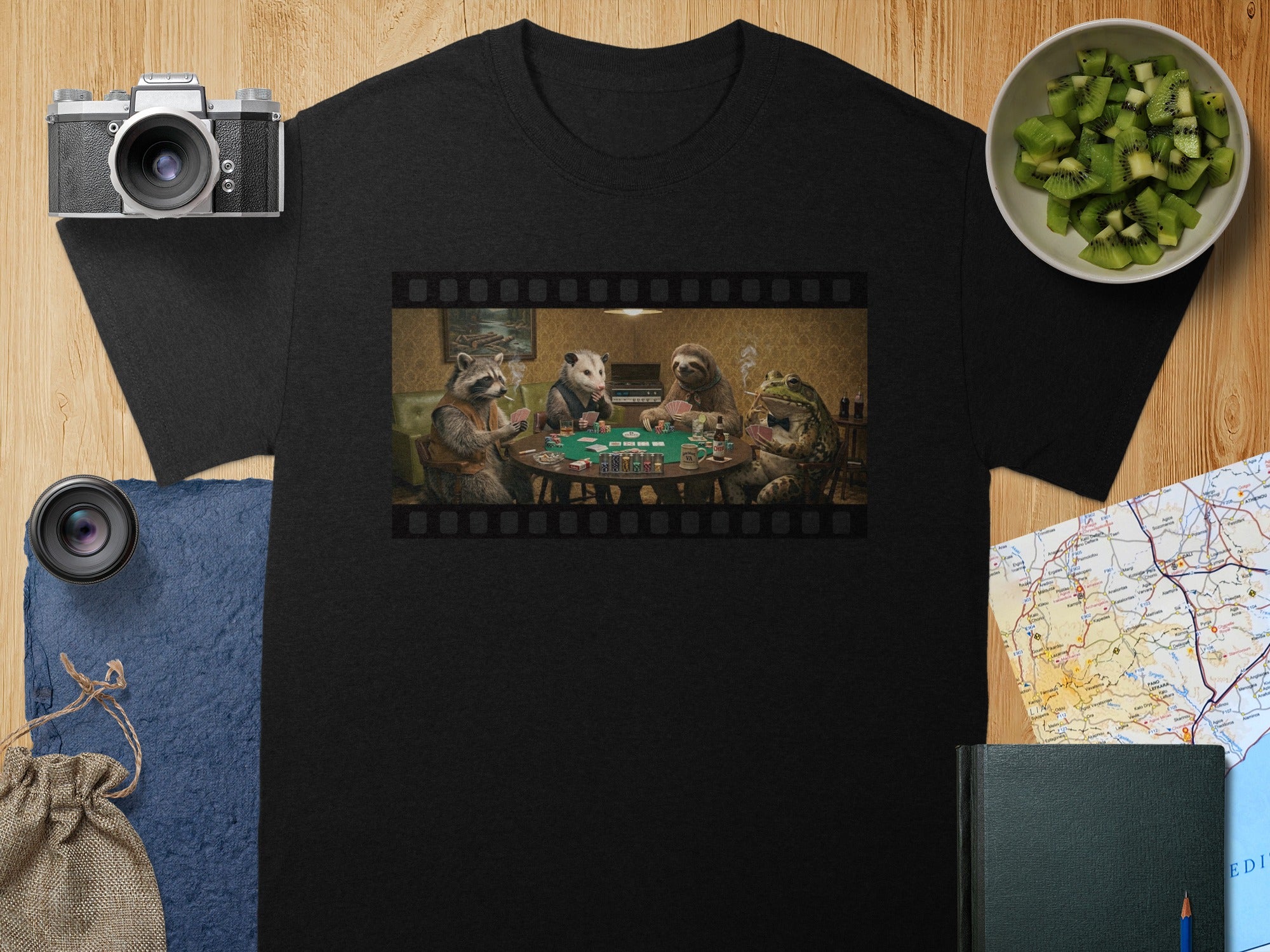 Black t-shirt with a film strip design featuring animals playing poker.