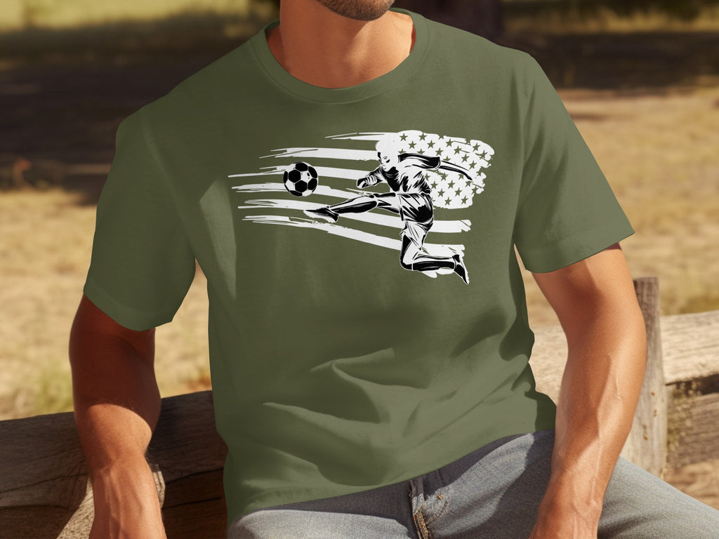 Soccer player kicking ball with distressed American flag design on olive green shirt.