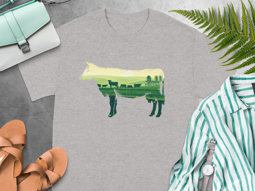 Grey t-shirt with a cow silhouette filled with a farm scene and animals.