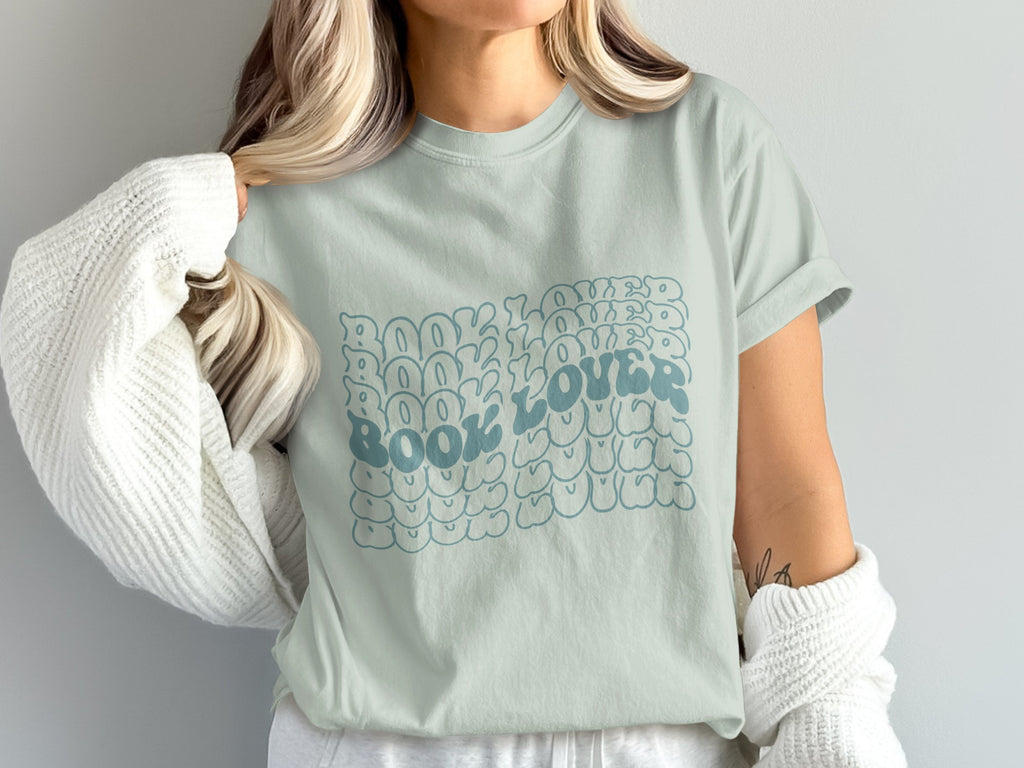 Light blue t-shirt with "Book Lover" text in a bubbly, retro font.