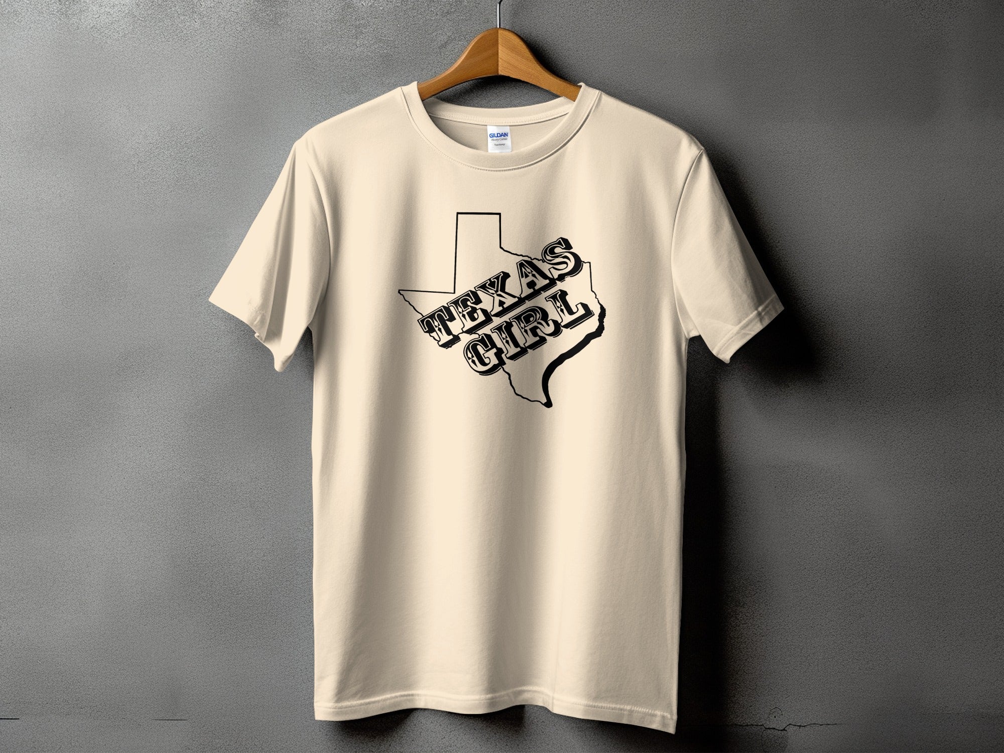 Cream t-shirt with black outline of Texas and "Texas Girl" text graphic.