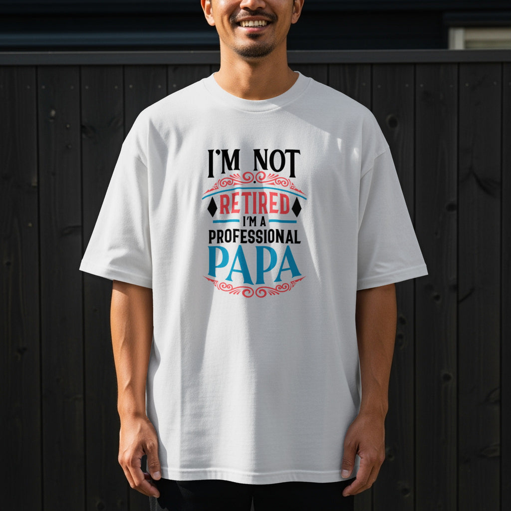 White t-shirt with "I'M NOT RETIRED I'M A PROFESSIONAL PAPA" text.