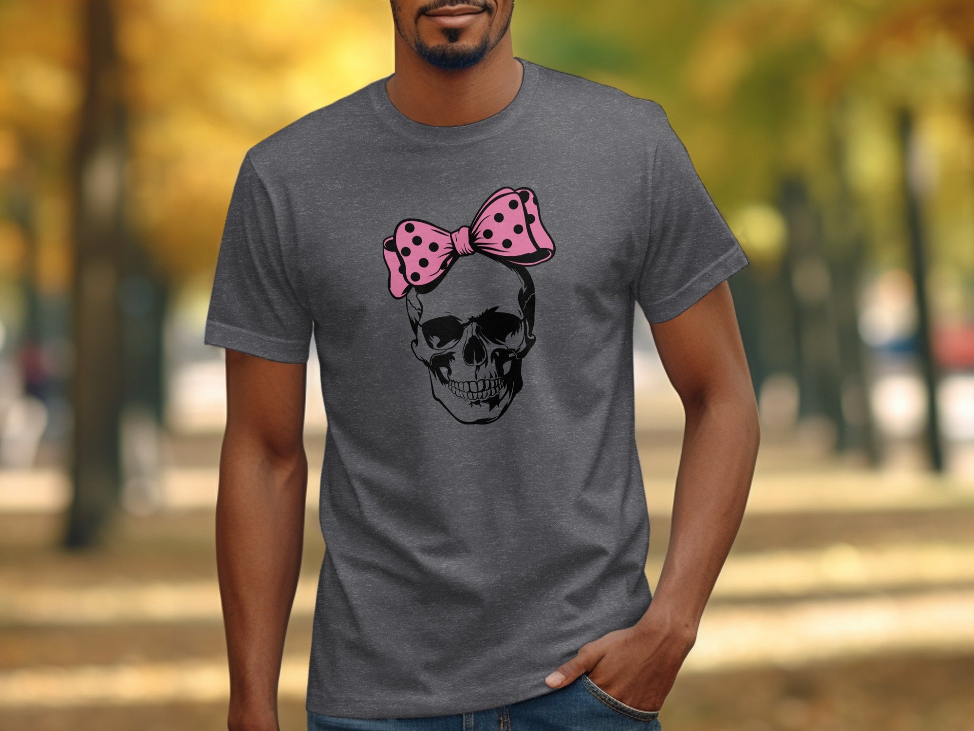 Dark grey t-shirt with a black skull wearing a pink polka dot bow graphic.