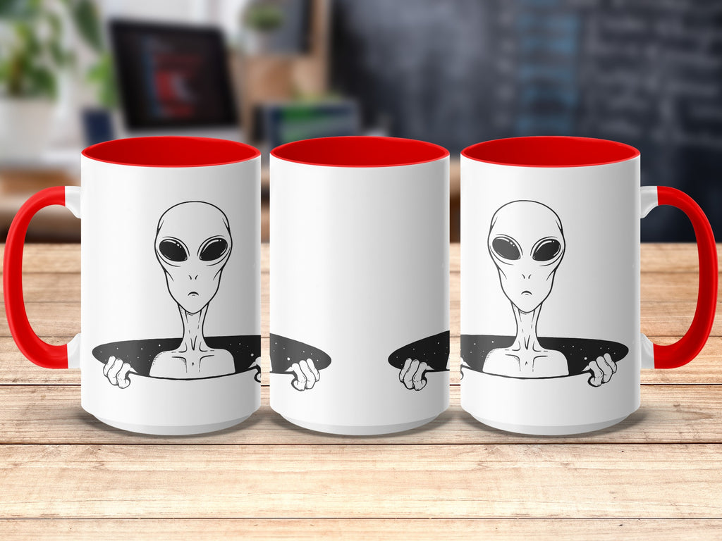 Three white mugs with red handles and rims, featuring a black alien illustration.