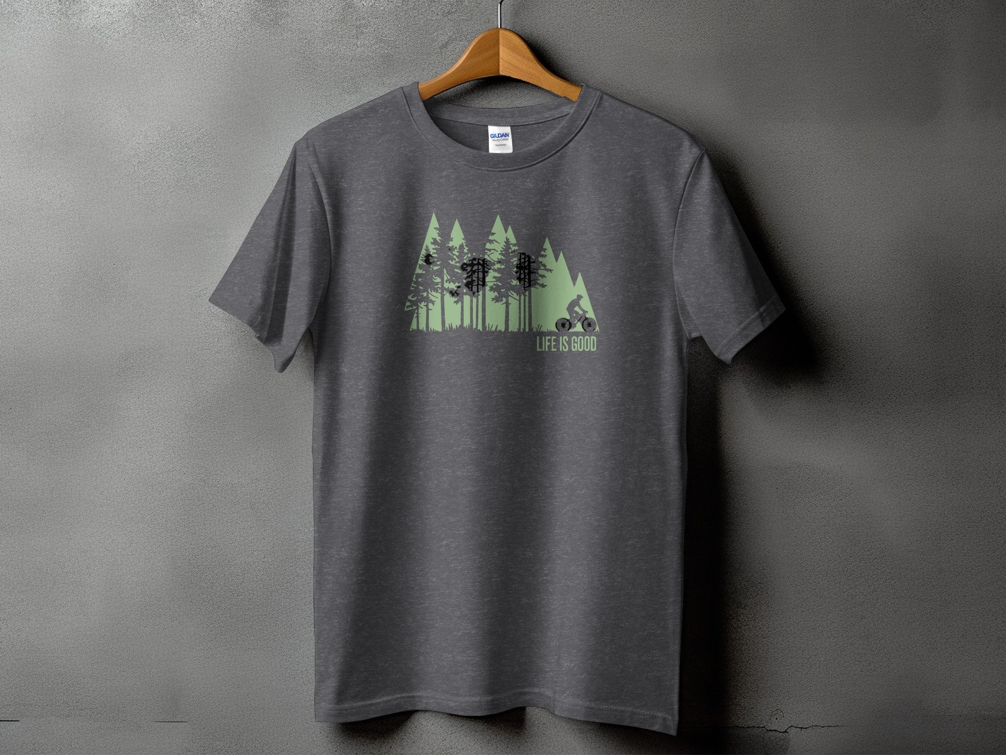 Dark grey t-shirt with a graphic of a cyclist and trees, reading "LIFE IS GOOD".