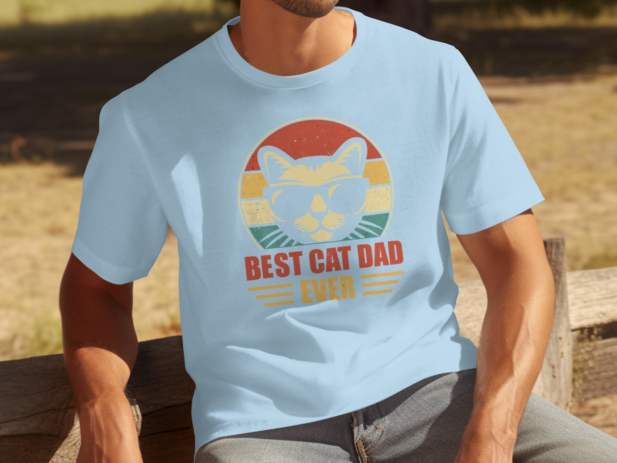 Light blue t-shirt with a retro graphic of a cat wearing sunglasses, reads "BEST CAT DAD EVER."