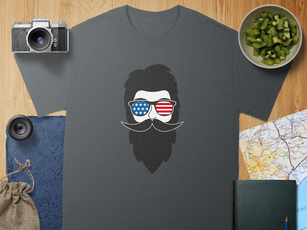 Gray t-shirt with a graphic of a beard, mustache, and sunglasses with an American flag pattern.