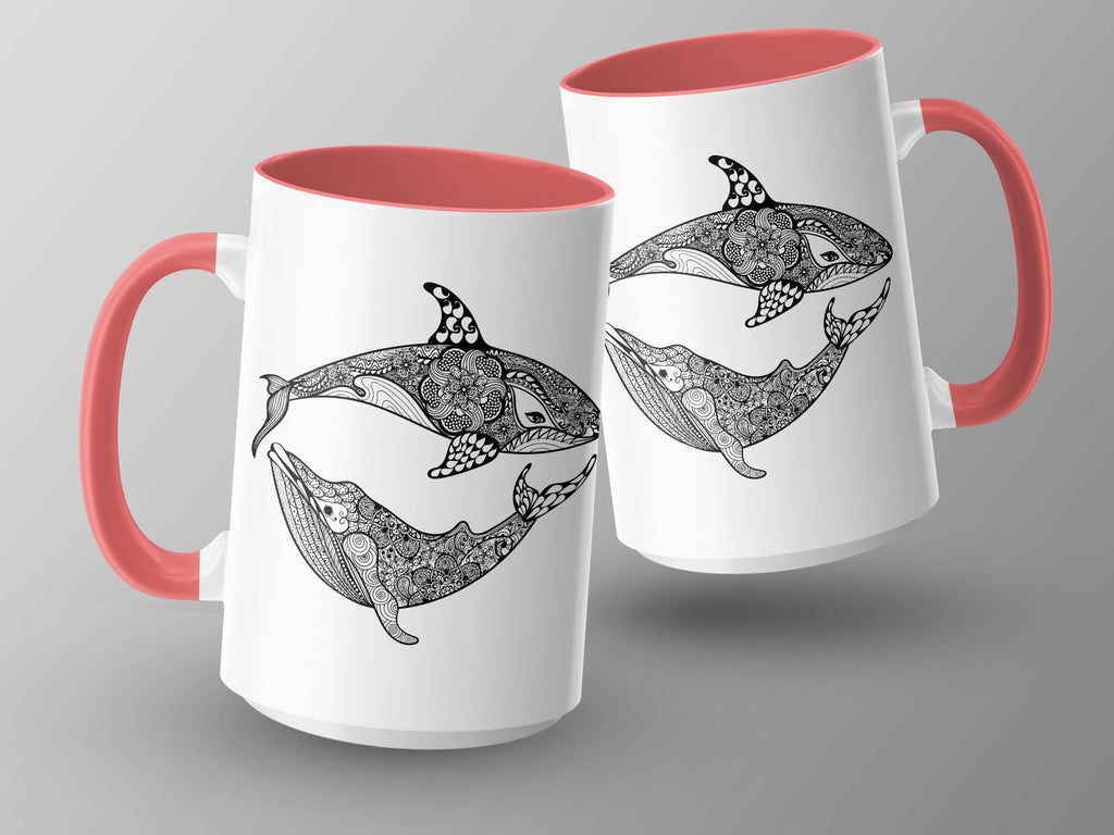 Two white mugs with coral handles, featuring black mandala-style whales and orcas.