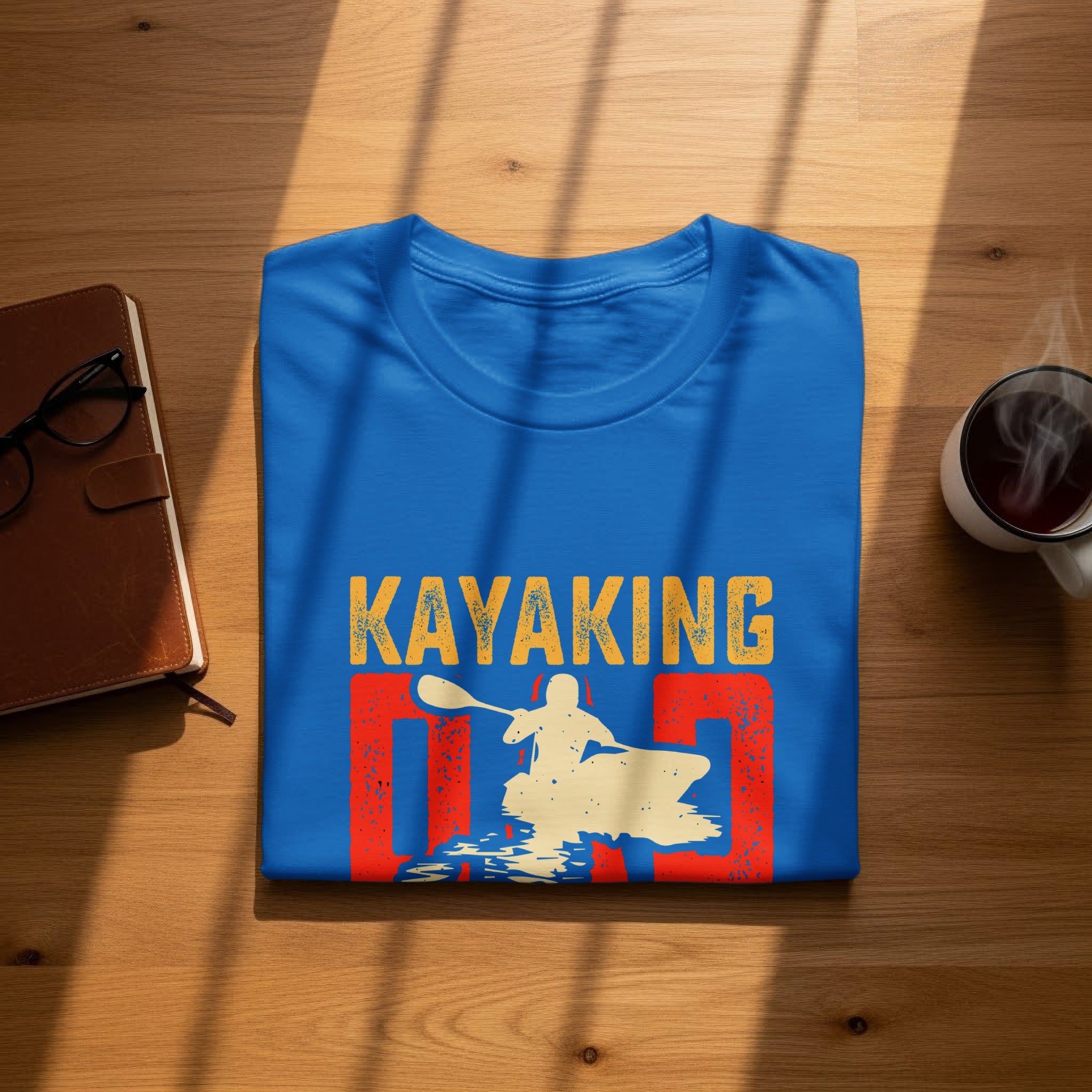 Blue t-shirt with "KAYAKING DAD" text and a kayaker graphic.