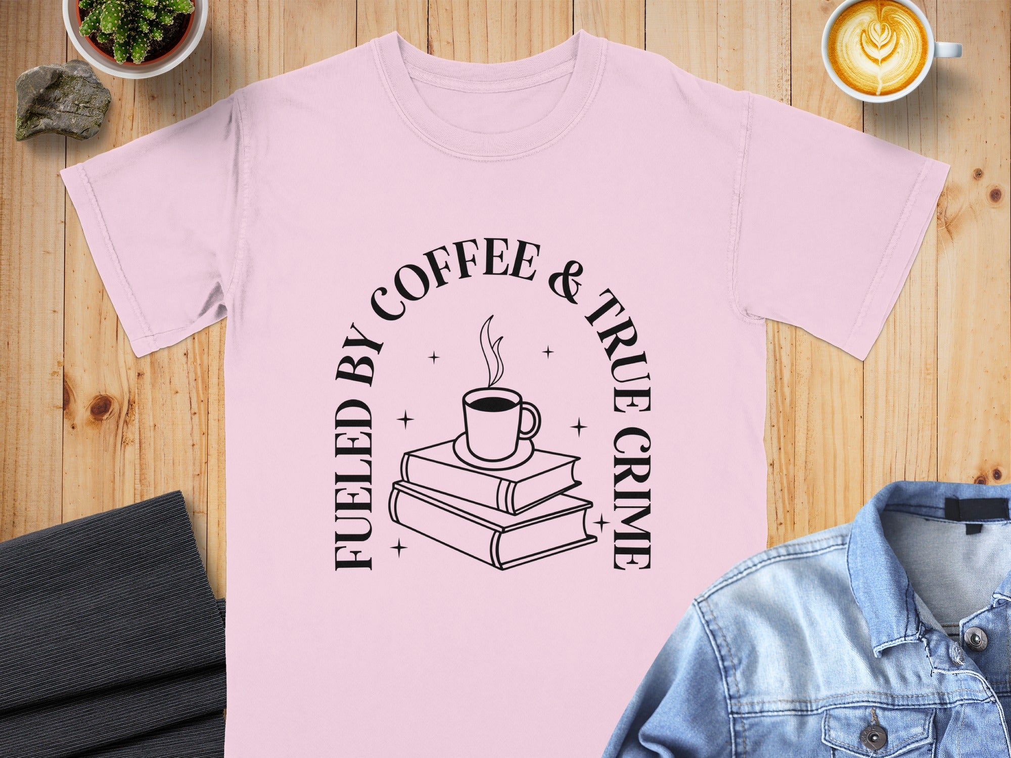 Pink t-shirt with "Fueled by Coffee & True Crime" graphic including books and a mug.