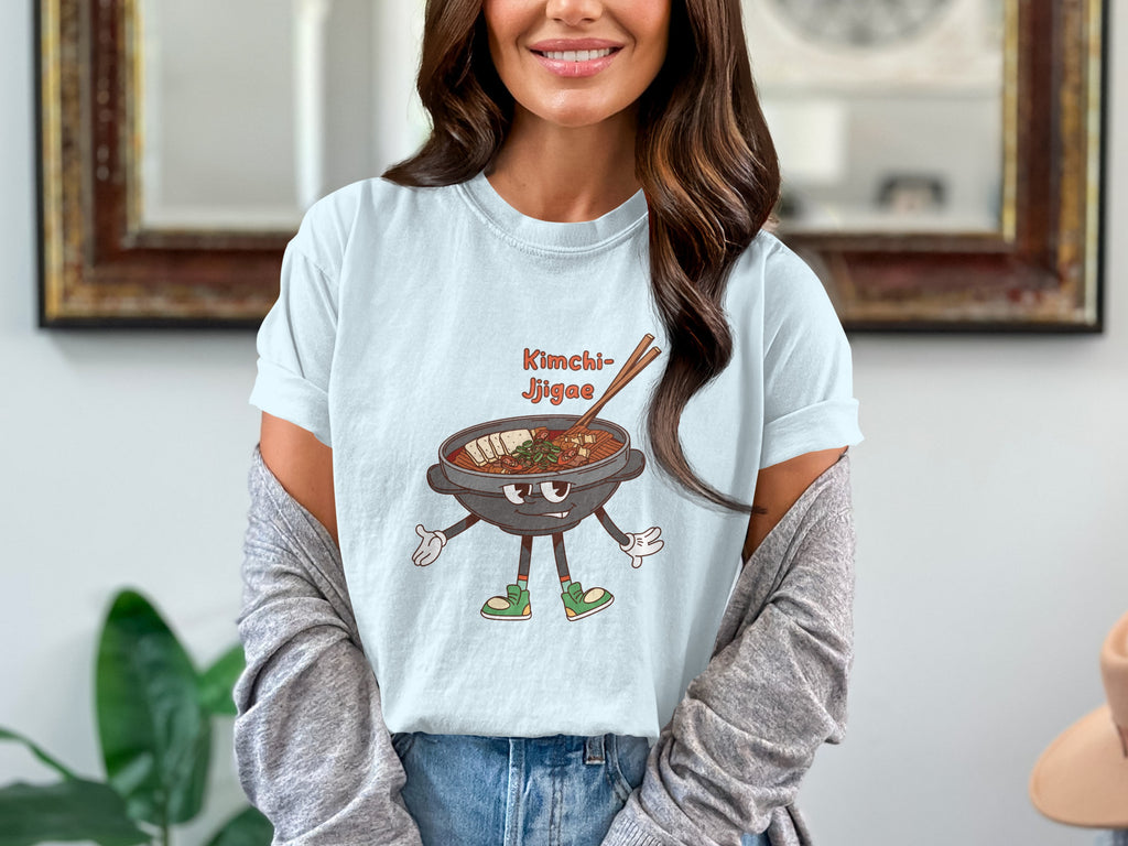 Kimchi Jjigae illustration on a light blue t-shirt with a cartoon pot character.