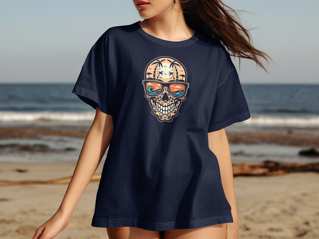 Dark navy t-shirt with skull graphic wearing sunglasses on a beach background.