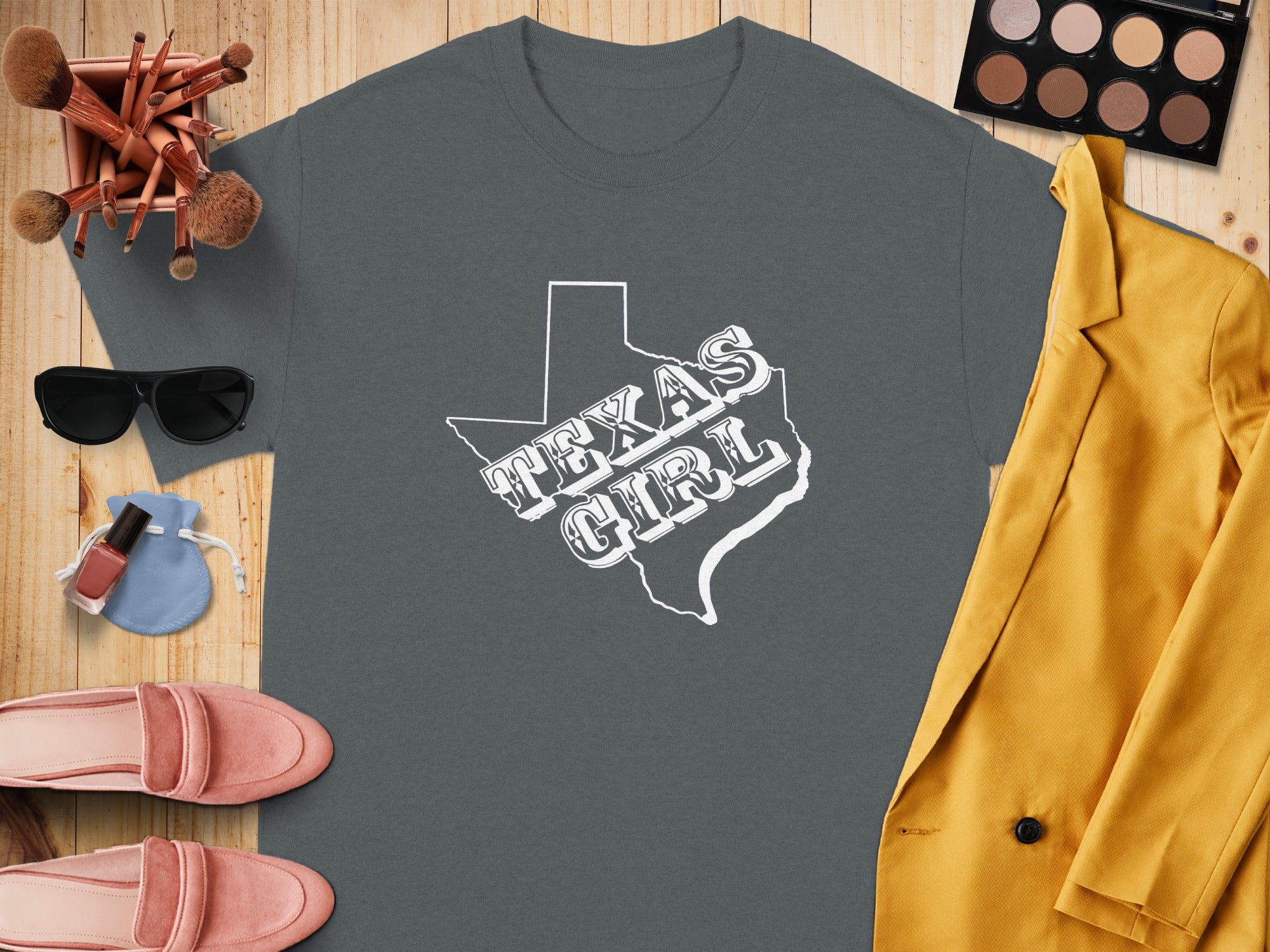 Grey t-shirt with white "Texas Girl" text inside the Texas state outline.