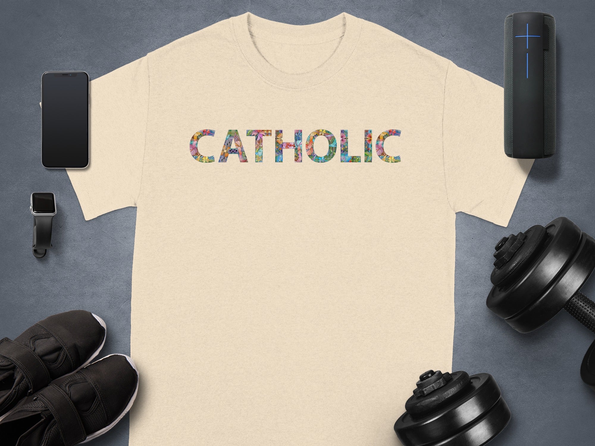 Light beige t-shirt with "CATHOLIC" in colorful patterned letters.