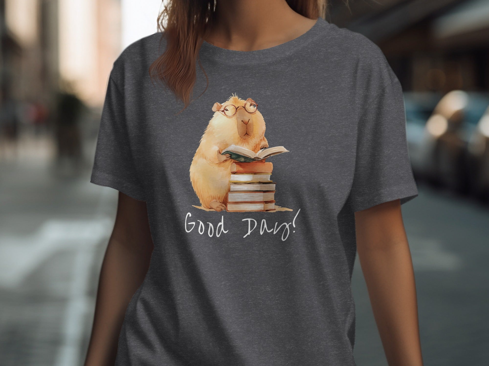 Illustration of a capybara wearing glasses reading a book on a stack of books with "Good Days!" text.
