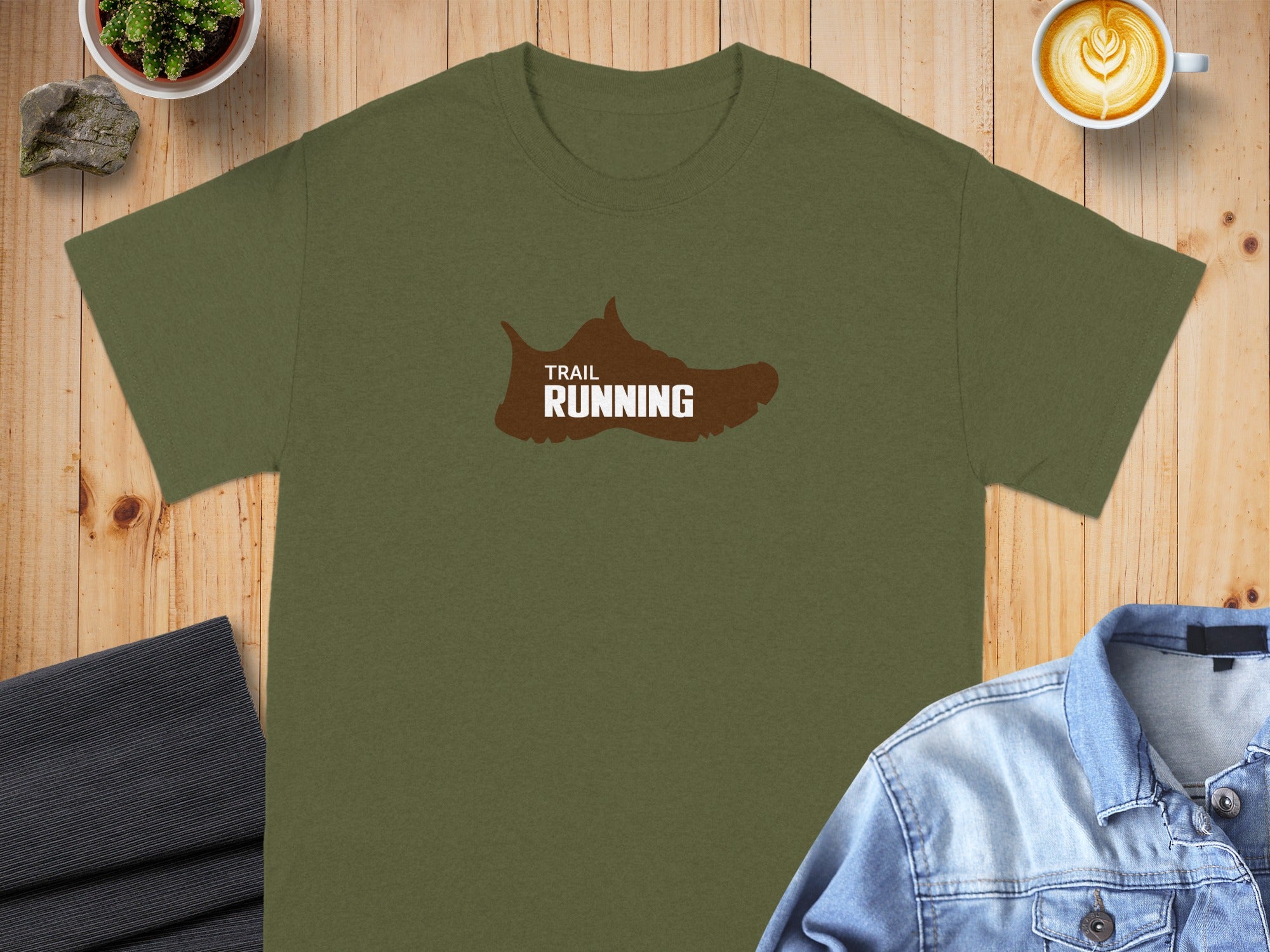 Olive green t-shirt with brown trail running shoe graphic and text.