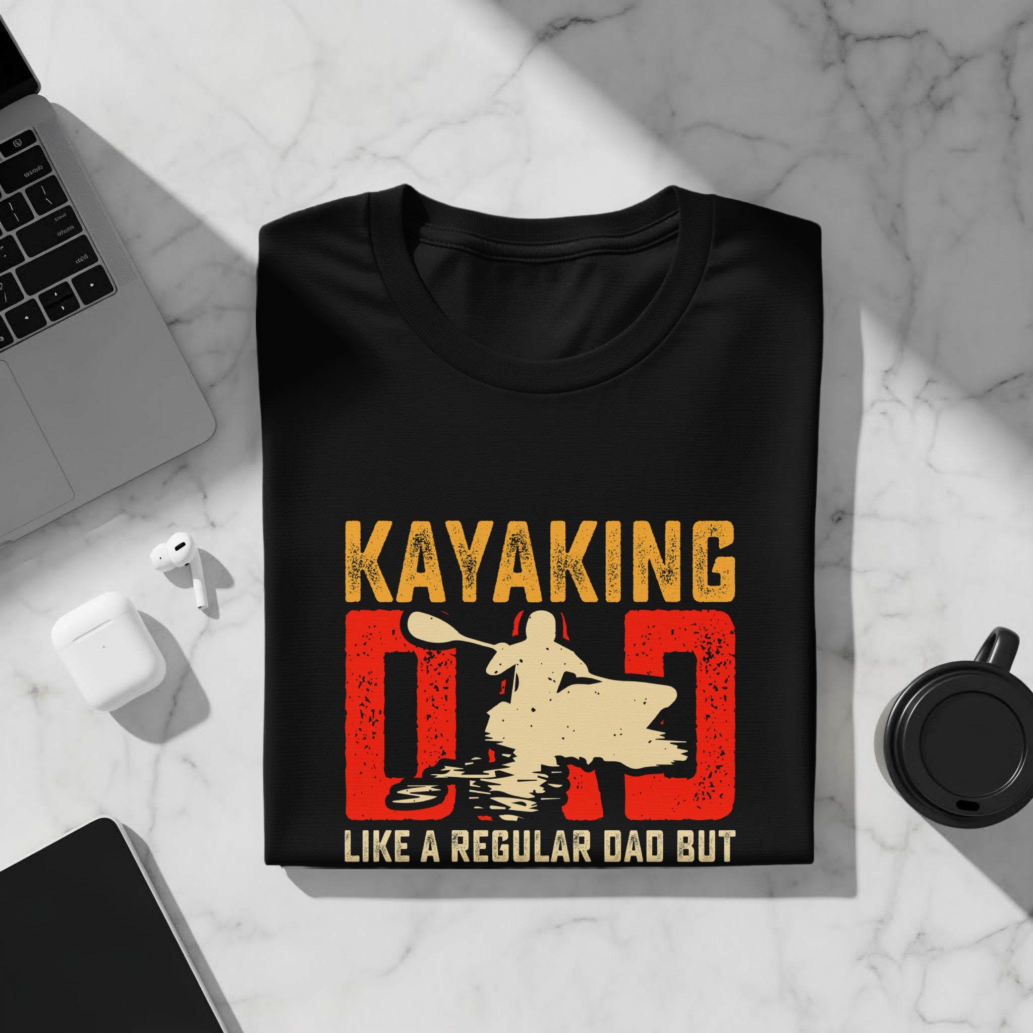 Black t-shirt with "KAYAKING DAD" graphic of a kayaker and text "LIKE A REGULAR DAD BUT".