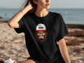 Black t-shirt with a cartoon ape wearing sunglasses and a trucker hat.