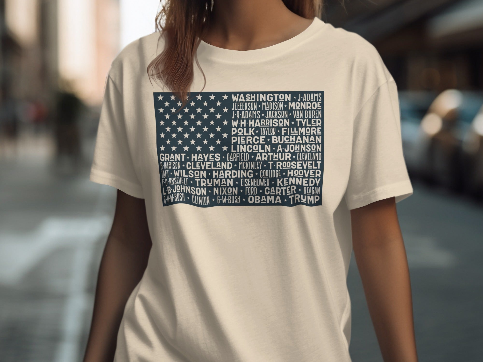 Cream t-shirt with a navy blue American flag graphic listing US presidents' names.