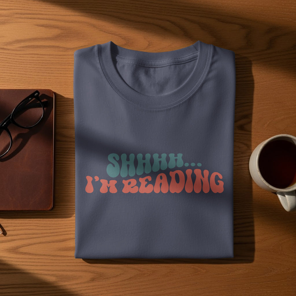 Dark blue t-shirt with "SHHHH... I'M READING" graphic in retro font.