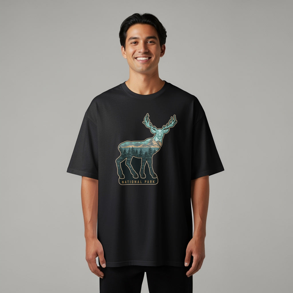 Black t-shirt with a deer silhouette filled with a forest and mountain landscape.