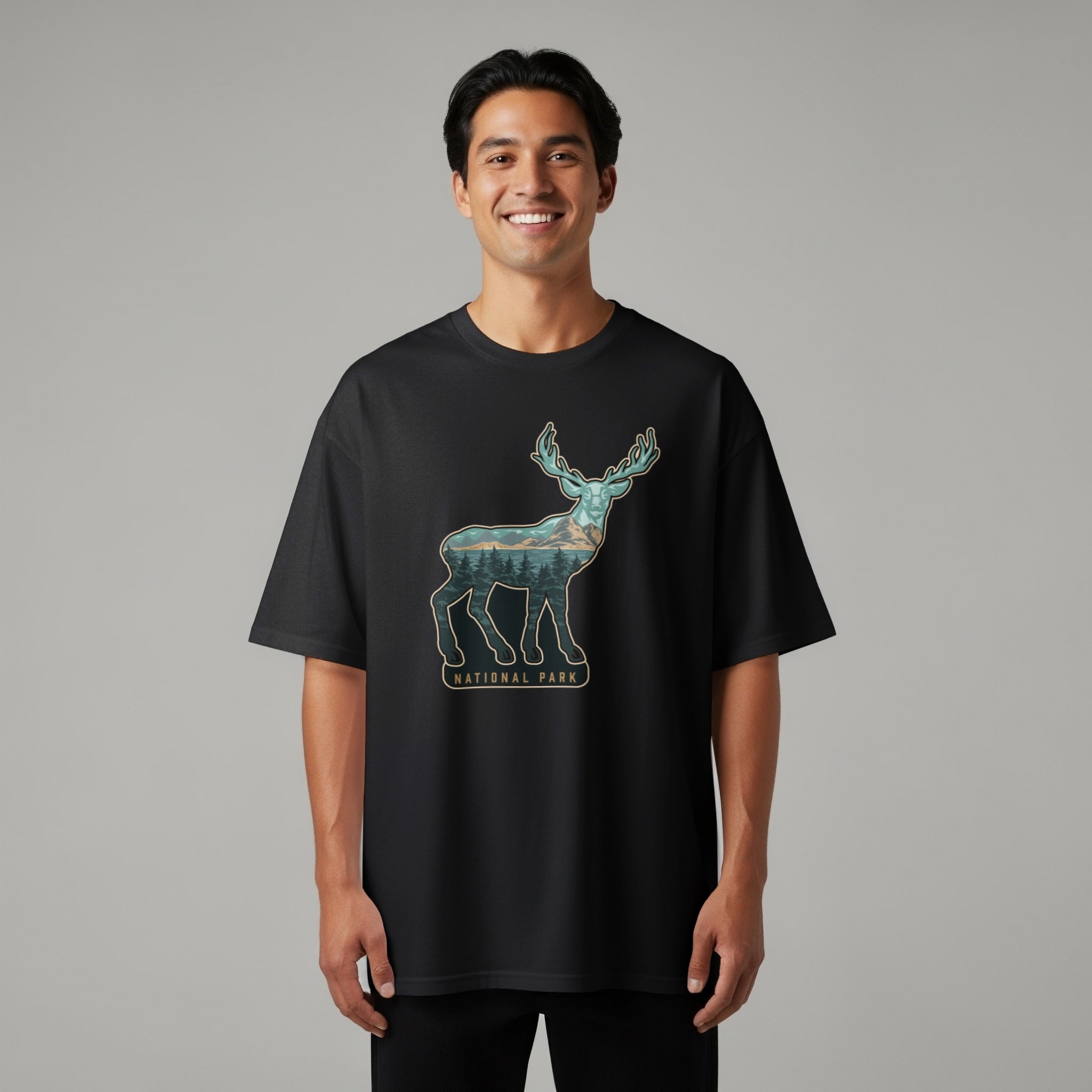 Black t-shirt with a deer silhouette filled with a forest and mountain landscape.