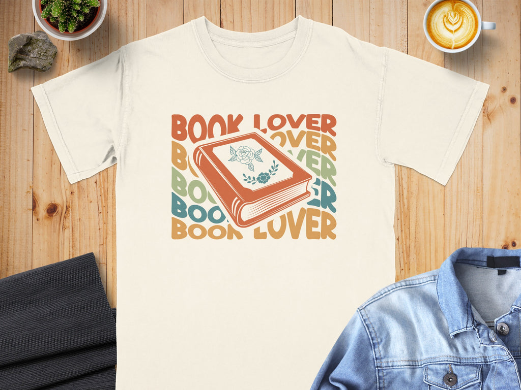 Cream t-shirt with "BOOK LOVER" text and an illustration of an open book.