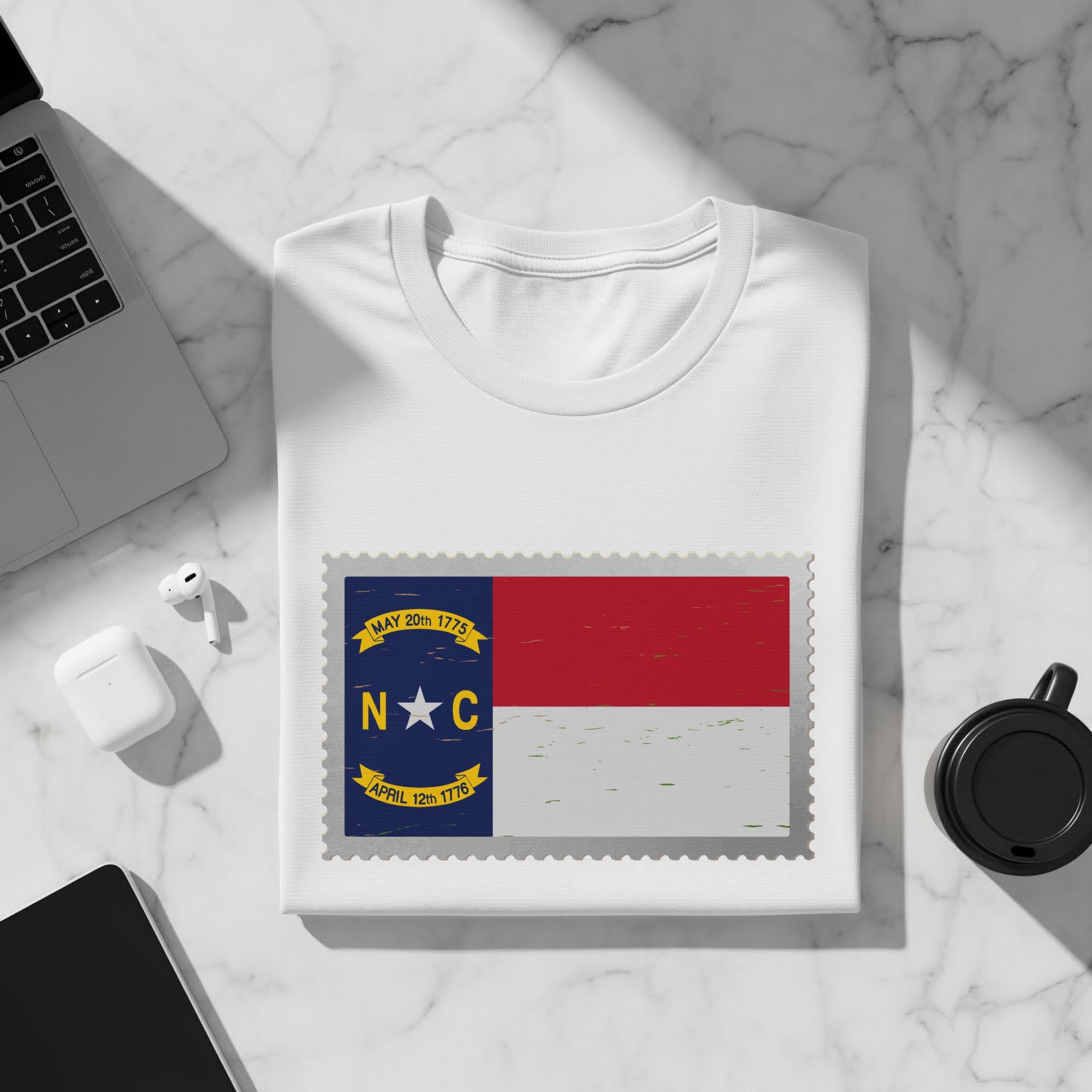 White t-shirt with North Carolina flag design and dates May 20th 1775 and April 12th 1776.