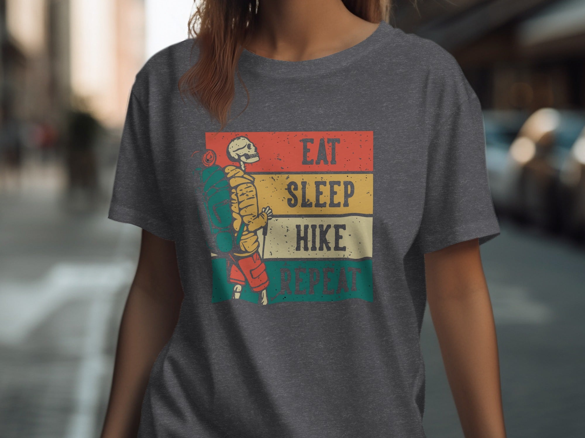 Skeleton hiker graphic with text "Eat Sleep Hike Repeat" on a t-shirt.