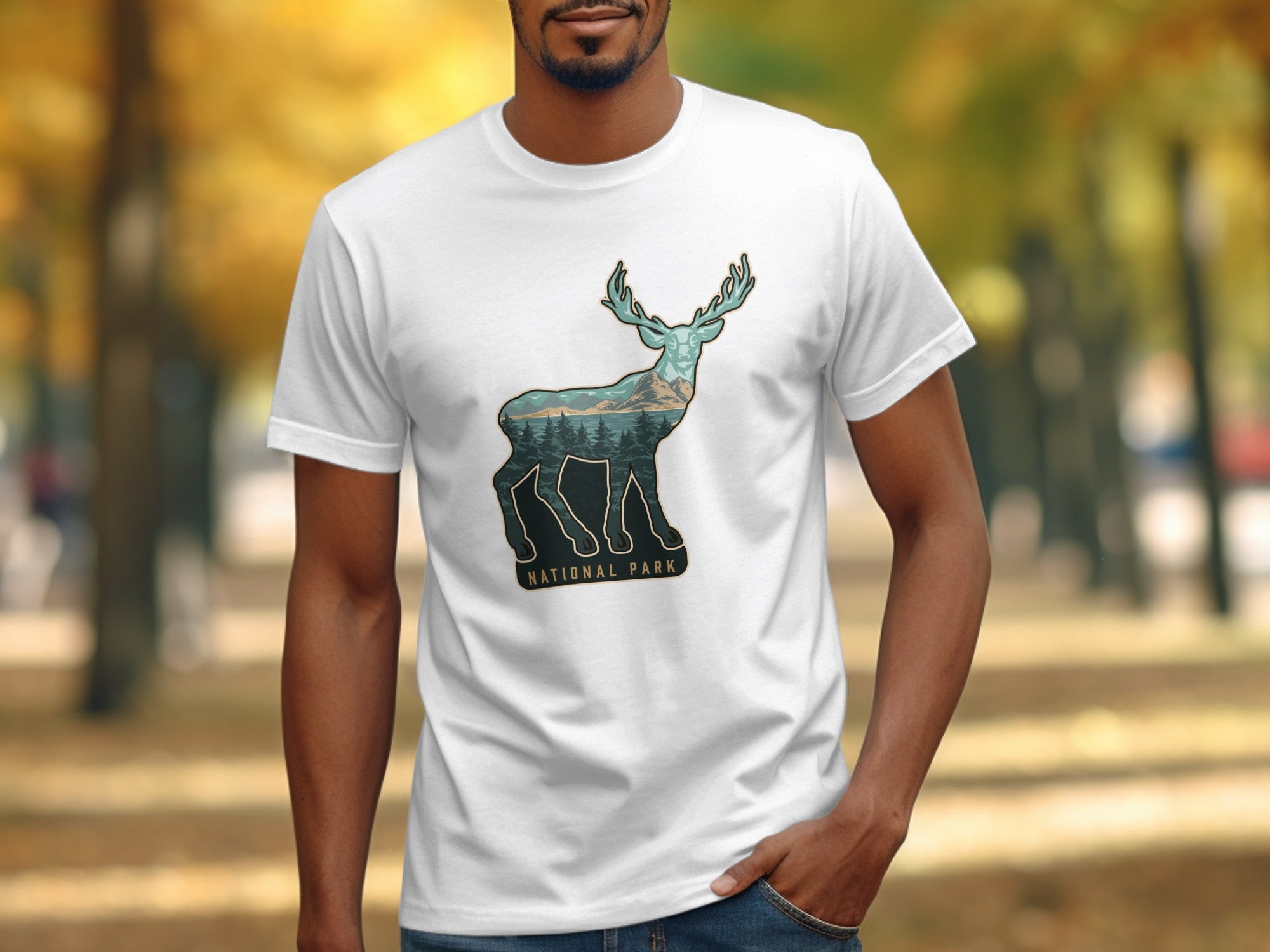 White t-shirt with a deer silhouette filled with trees and mountains, text reads "National Park".